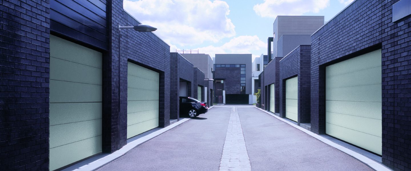 Car leaving garage at newly built housing estate