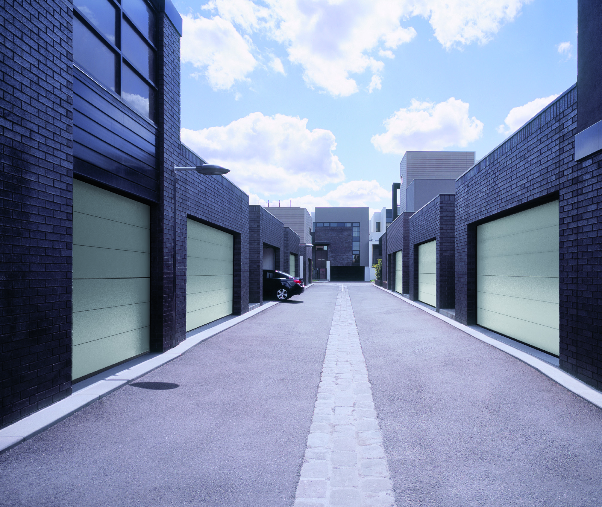 Car leaving garage at newly built housing estate